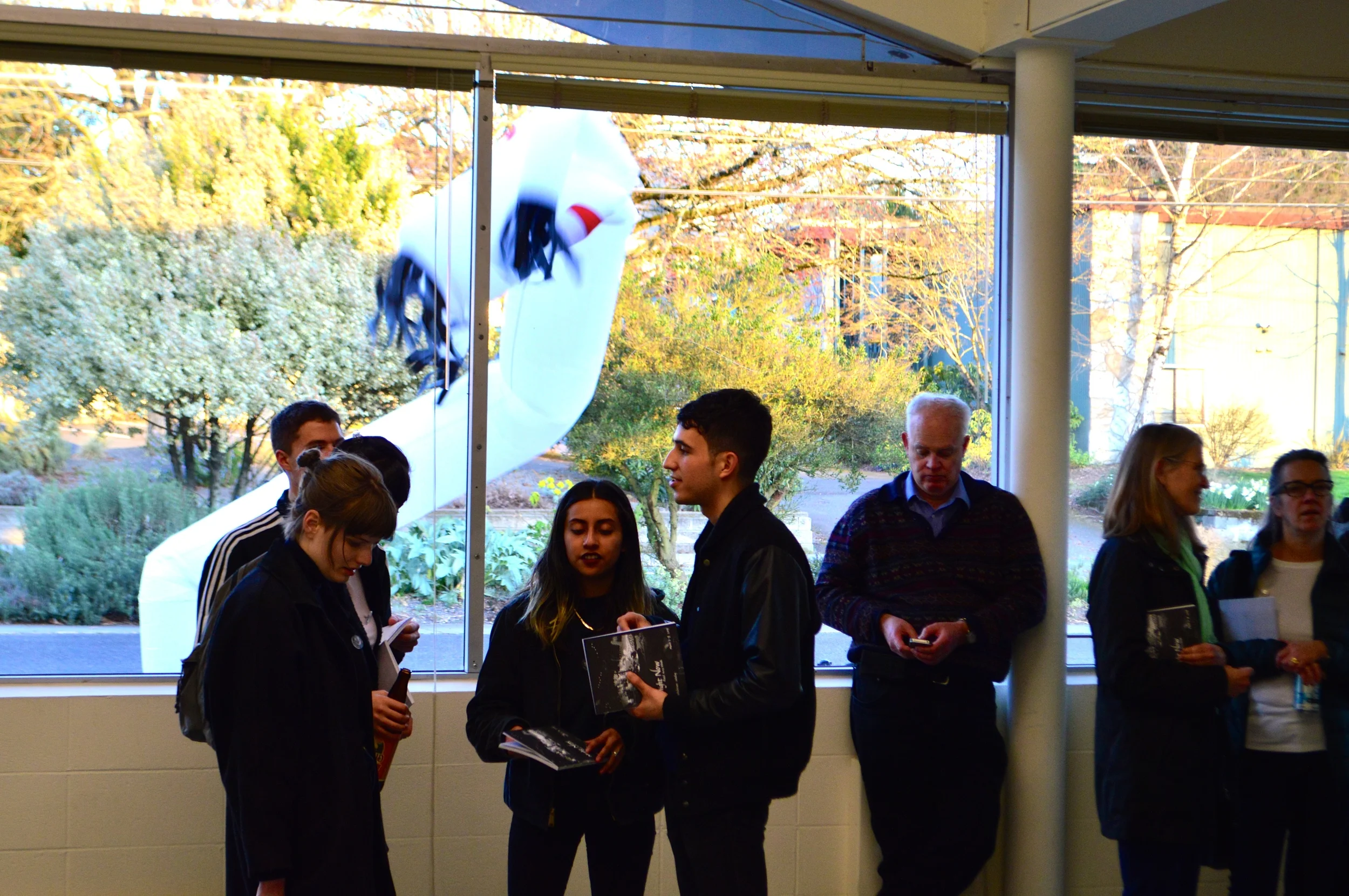 “Community members enjoy the opening day of RAW in the theater annex.”