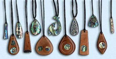 Traditional New Zealand jewelry using wordcarving and paua shells. Source