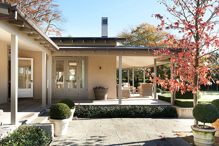 A view of the side patio which opens into the main living space. Source