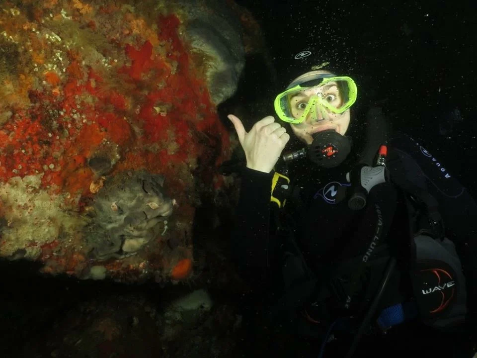 OK, you can hardly see them, but I'm very excitedly pointing at nudi branchs on the wall. They're my favorite!