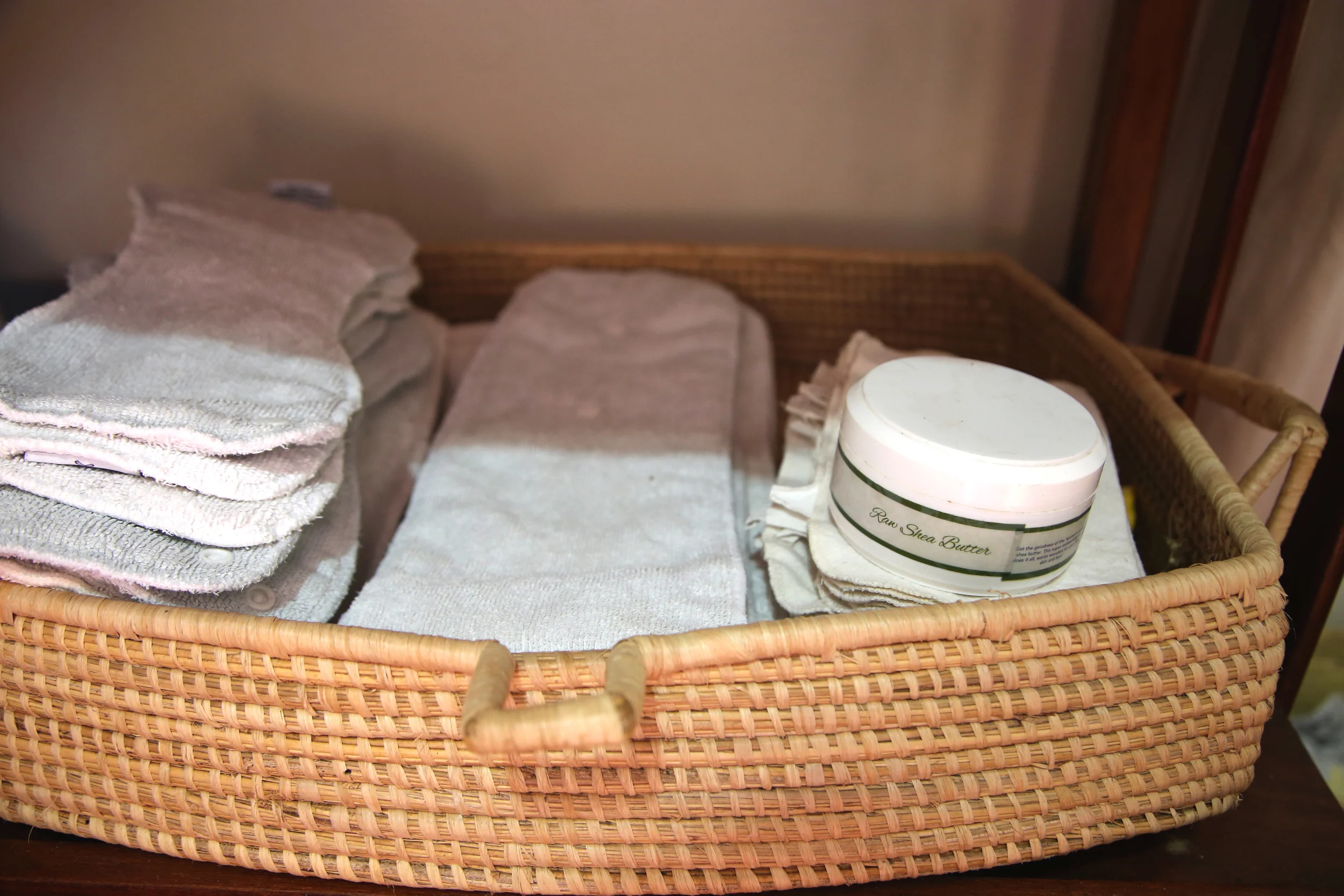 Diaper basket woven in Uganda from palm leaves. Pure shea butter made in Uganda and available at Baby Lionheart .