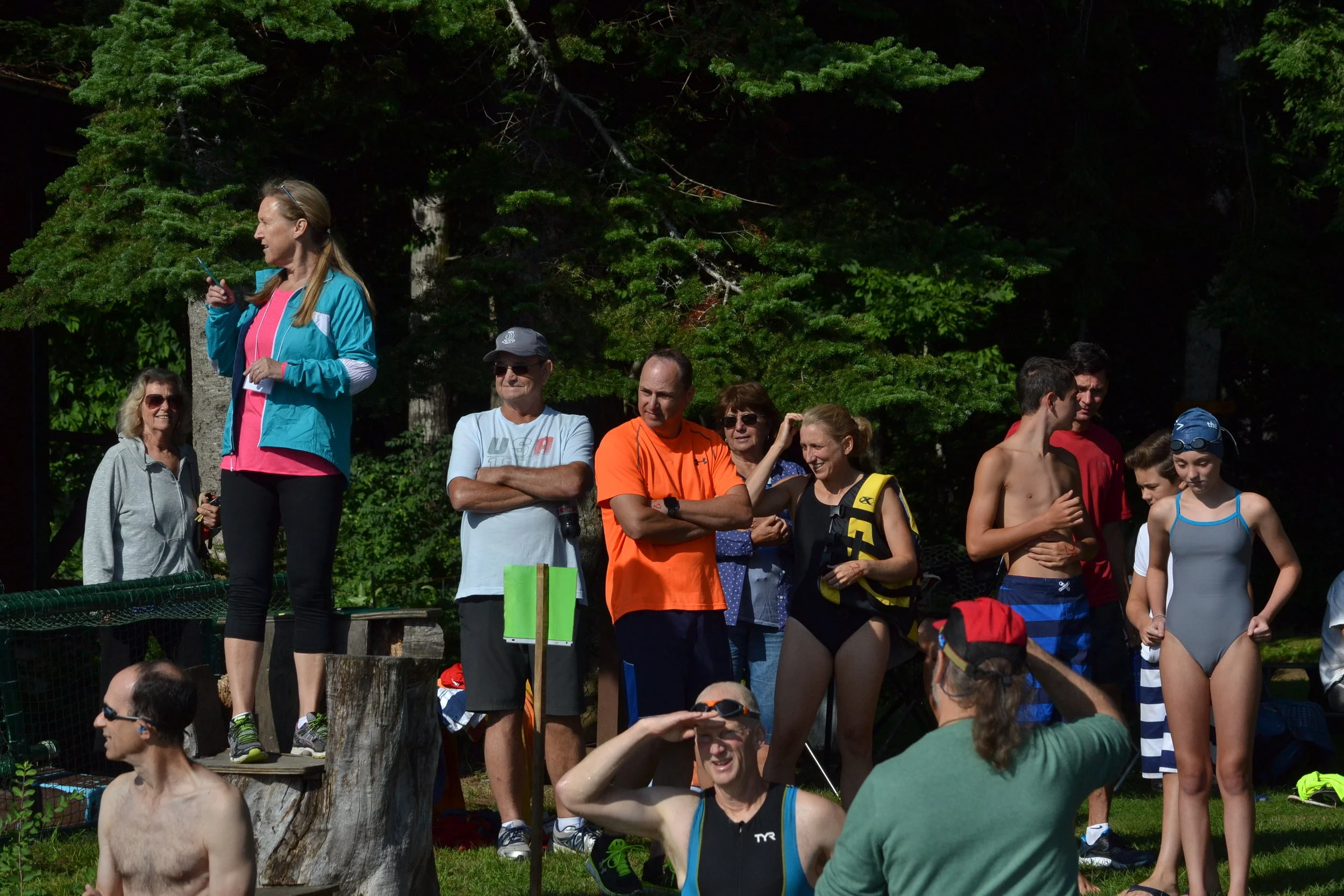 Race organizers and spectators at start of tri-sport