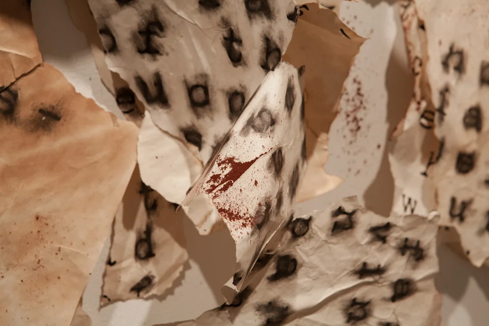 The Indictment of Cora Montgomery. 2015. Exhibit and installation. performance relic, paper, red pigment. Guadalupe Cultural Arts Center