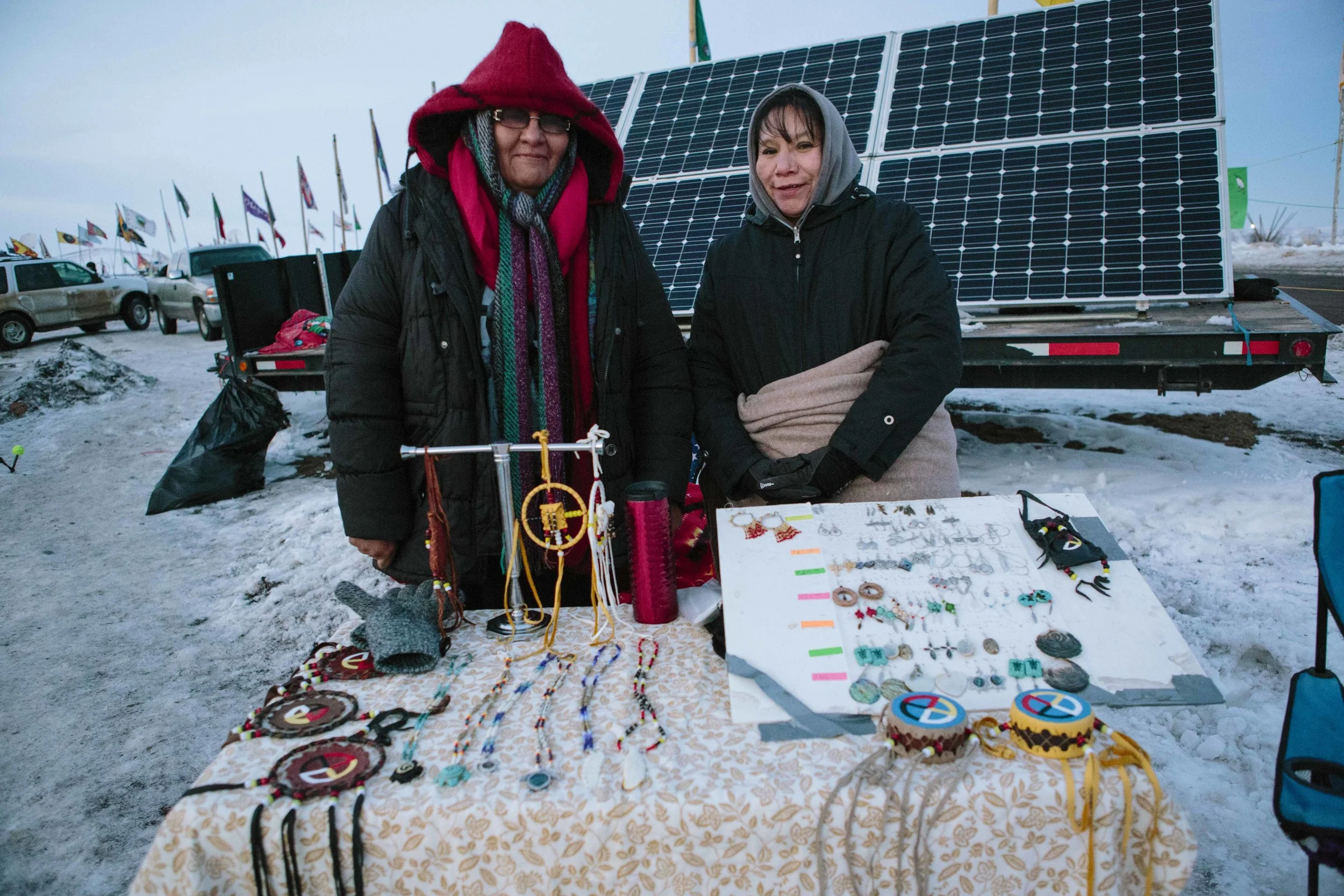 Lakota women sell handmade jewelry near the Sacred Fire