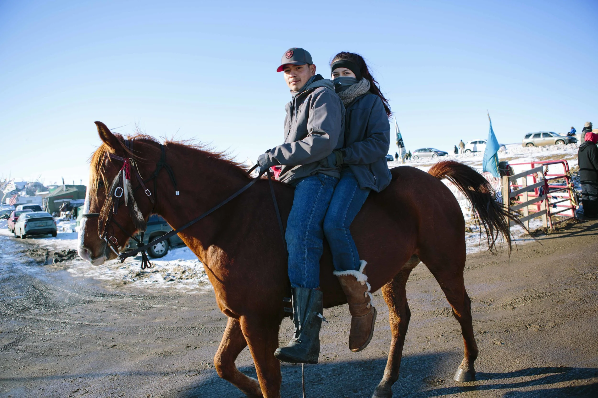 Lakota tribesmen enter Oceti Sakowin on horseback