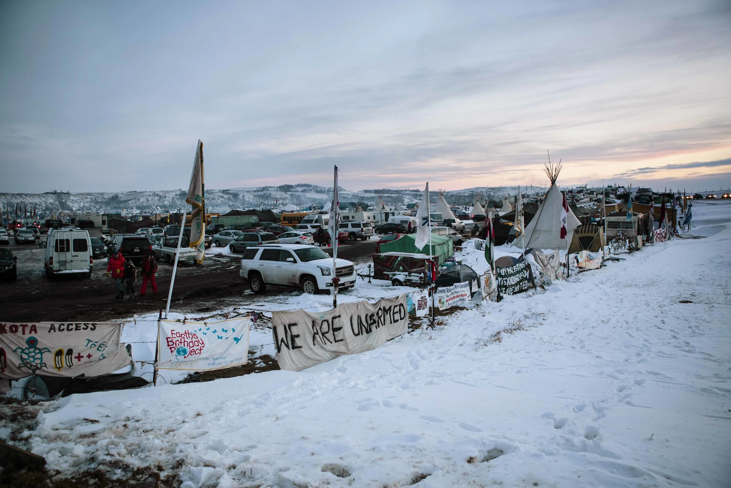 Oceti Sakowin entrance reads "We Are Unarmed"