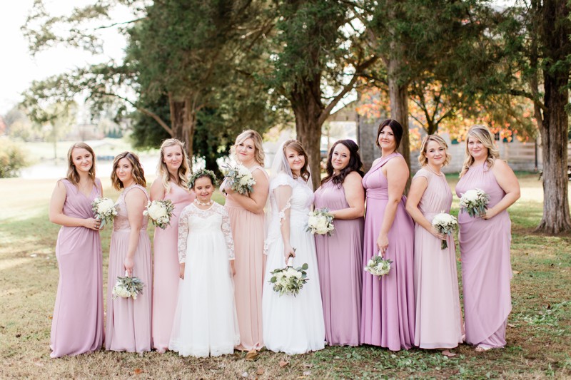 Bridesmaids wearing different shades of blush