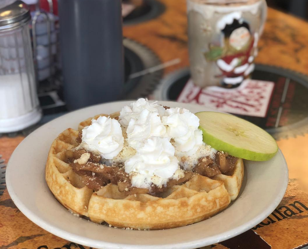 PHANTOM OF THE ORCHARD - Waffle topped with apple compote, whipped cream, and caramel drizzle