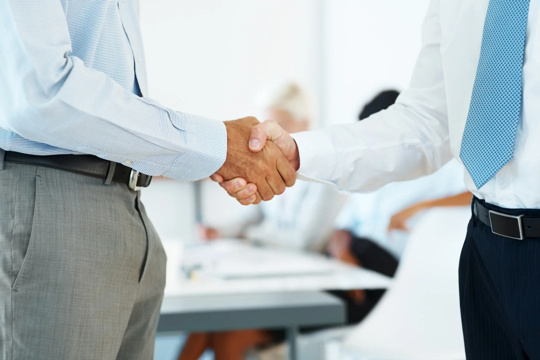 Handshake of business partners after striking deal Handshake of business partners after striking deal