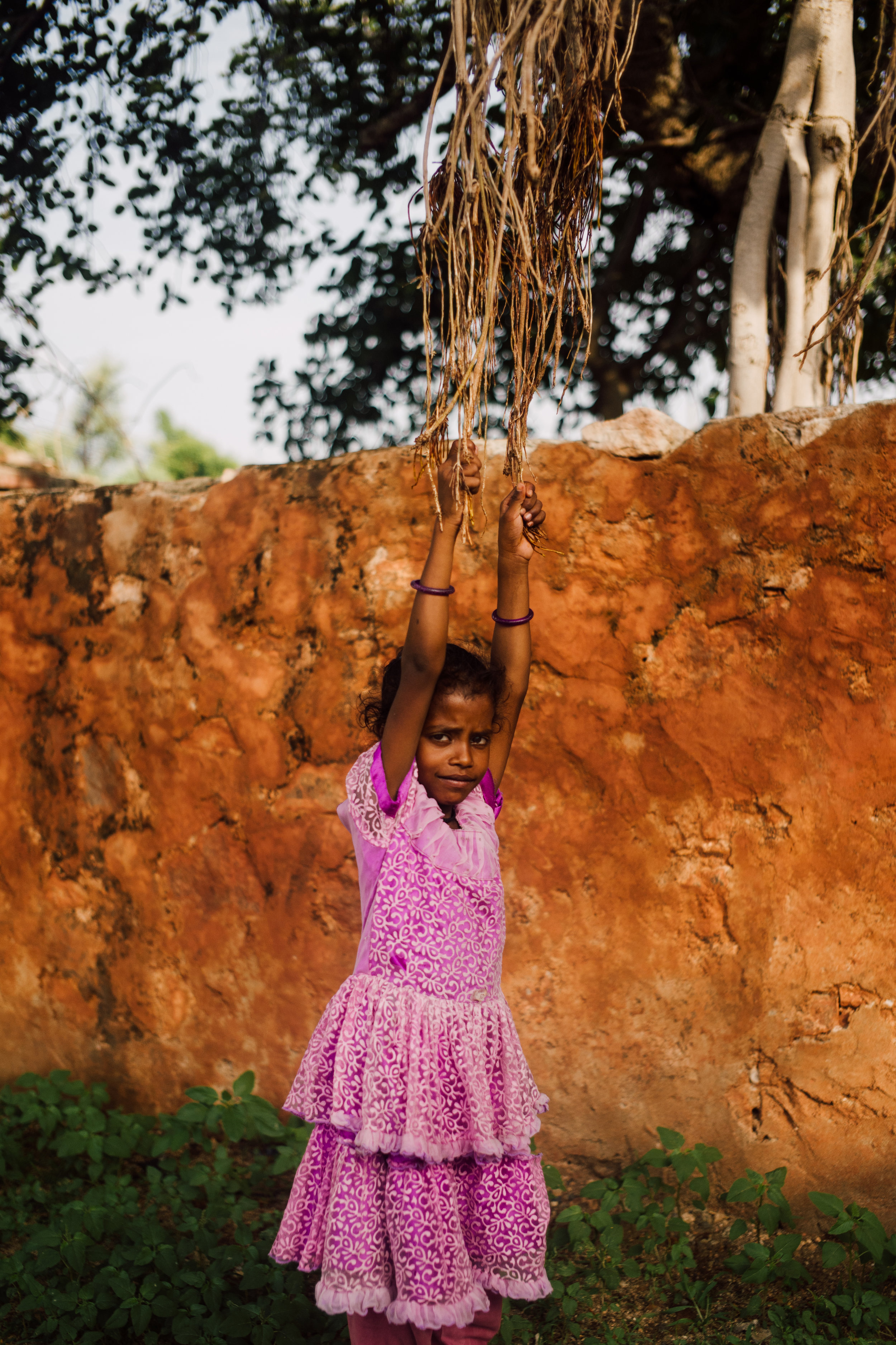 On my journey from Jodhpur to Udaipur, we pulled off the side of the road to take a breather. Here we found a girl swining from a set of tree vines, she would use these tree vines and the wall behind her as a makeshift swing.