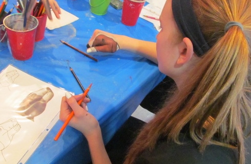 Michayla painting her hand to look like a dog.
