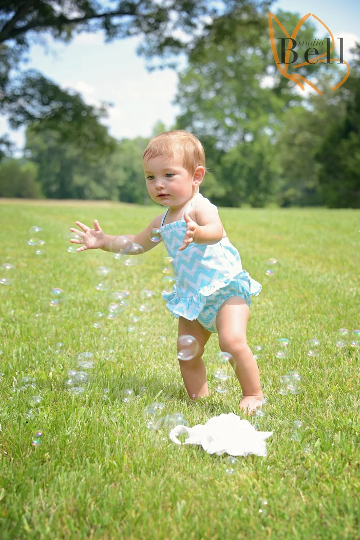 she finally did it! Do you see it? That slightly bent knee... she took her first step! I know it doesnt look like much but I am sure all parents can understand what a big moment it was when a child takes their first step. And in true Aubrey fashion it was during a photo shoot! Love that little tater tot to pieces, as if she didnt already have my heart, she sure went after it with that slick move :)