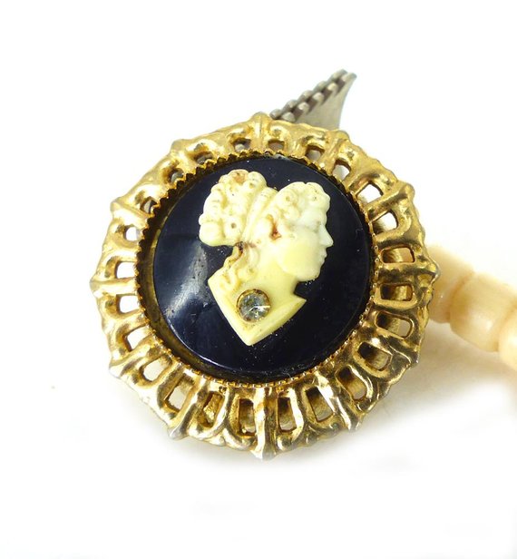 Black and cream open gold frame with rhinestone detail magnetic brooch