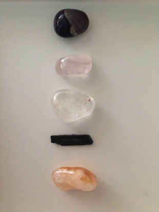 Starter kit of tumbled stones. From the top: Amethyst, Rose Quartz, Clear Quartz, Black Tourmaline (raw) + Citrine. Click here to purchase.