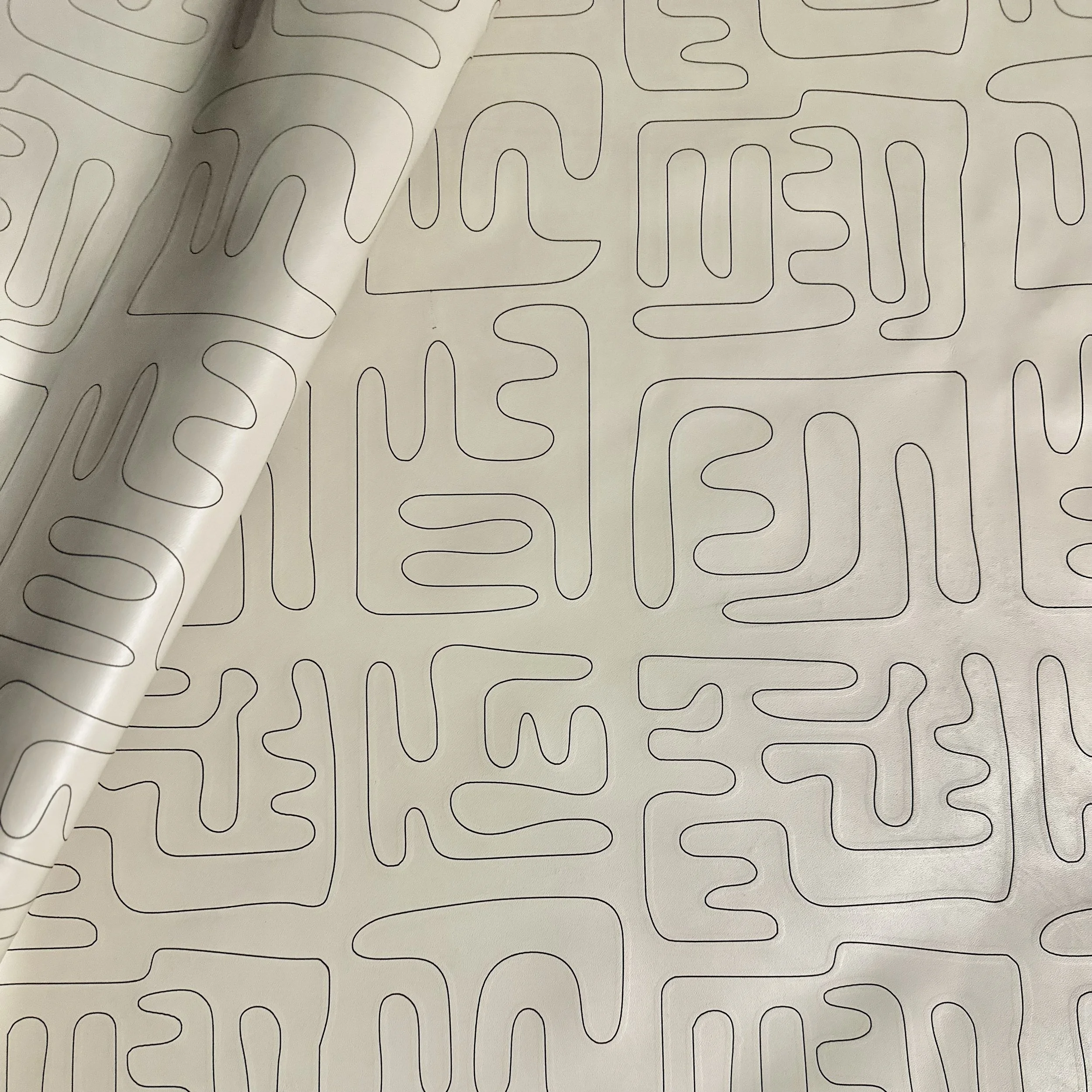 etched on Maude leather in color oyster