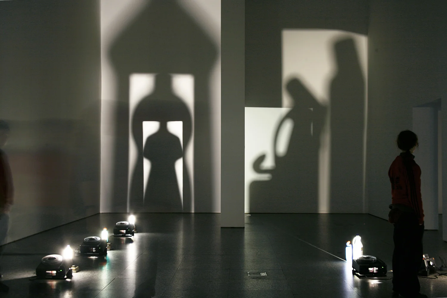 Eulalia Valldosera, Envases el culto a la madre, 1996 Series of 4 light installations 1996 (detail) 1. Woman Seed. 3 slide projectors without slides; 3 bottles of detergent, books 2. Trinity 2 slide projectors without slides; 3 bottles of detergent, mirror, books