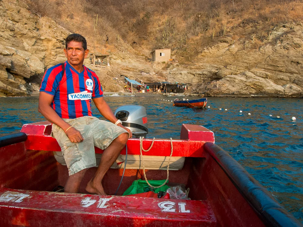 A man steers the boat away from the fishing cove, heading back to Taganga in the sunset. In this series, I photographed the daily happenings of a group of fishermen in the small town of Taganga, on the northern coast of Colombia. They use a simple yet effective method, common of indigenous groups, that has been passed down through generations. Their connection to the sea and their commitment to this way of life persists despite the amassing threats of pollution and over-fishing by commercial enterprises.