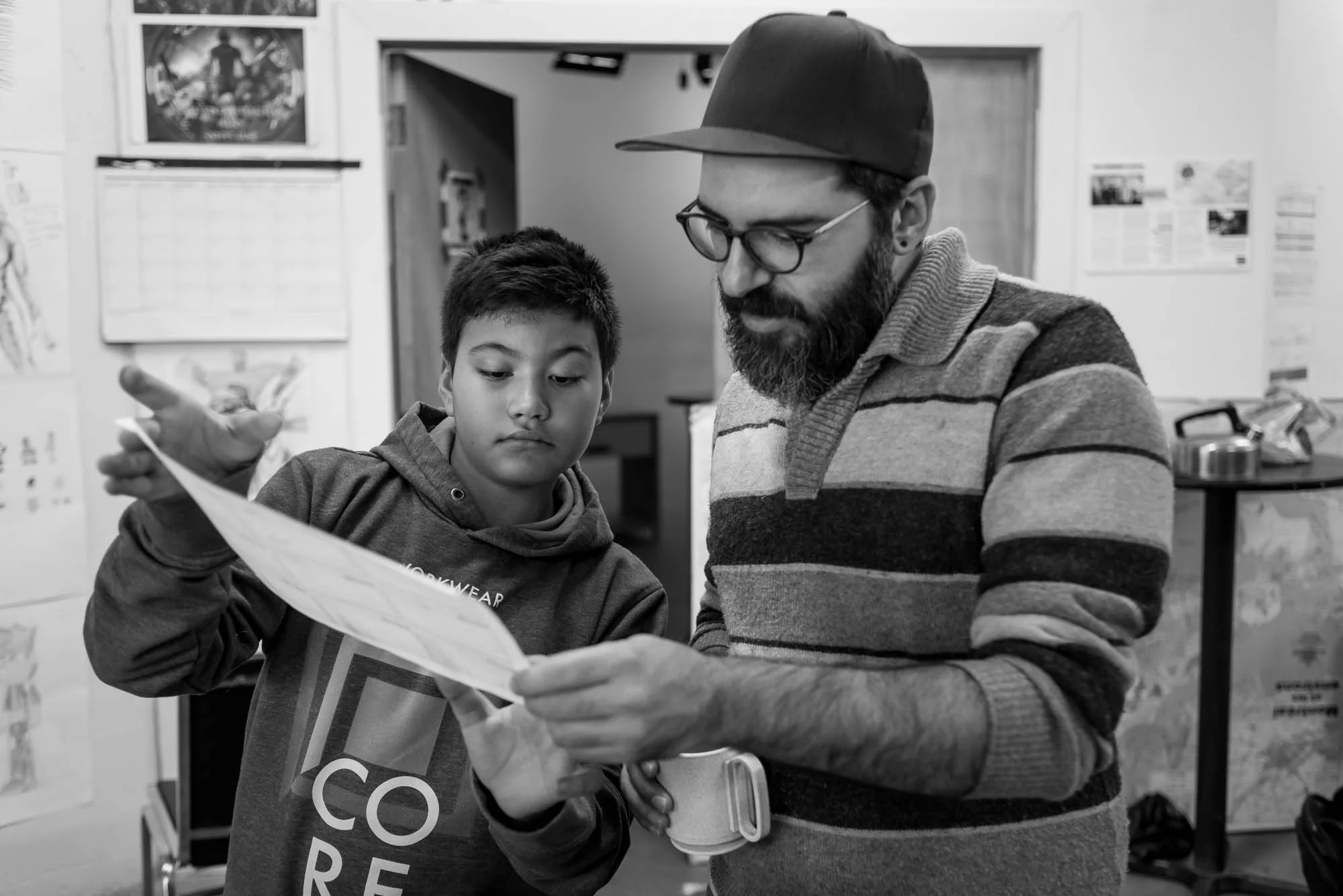 Raphael shows Felipe his revised story board for the animation he is creating. Facilitator to participant feedback and support is essential to developing story ideas. In this photo essay I show youth on the autism spectrum engaged in programming at Spectrum Productions. Spectrum Productions provides an opportunity for youth to gather together - they imagine, story board, write scripts, draw and create video while interacting with each other and with staff, something that is not always an easy task. 