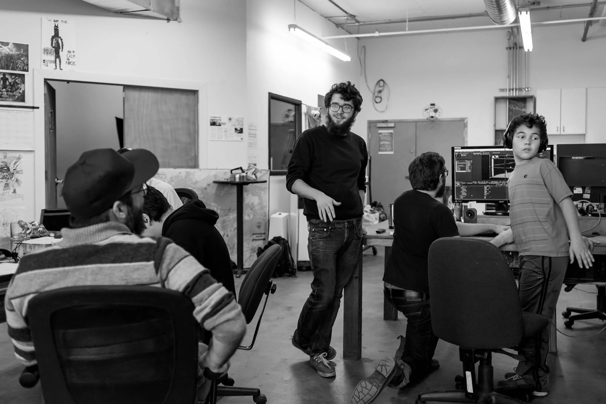 Loic, (left) a program facilitator interacts with Filipe as Raphael (right) turns to see another participant’s work. Peer editing and revising are encouraged at the Saturday morning cartoon club. In this photo essay I show youth on the autism spectrum engaged in programming at Spectrum Productions. Spectrum Productions provides an opportunity for youth to gather together - they imagine, story board, write scripts, draw and create video while interacting with each other and with staff, something that is not always an easy task