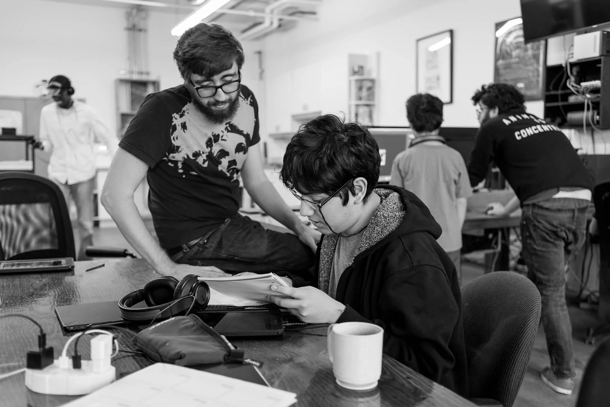 Calvin, a program facilator reviews Sebastien’s script with him while other participants and faciliators work in the back ground. The Saturday morning cartoon club works with about 10-15 participants each weekend. In this photo essay I show youth on the autism spectrum engaged in programming at Spectrum Productions. Spectrum Productions provides an opportunity for youth to gather together - they imagine, story board, write scripts, draw and create video while interacting with each other and with staff, something that is not always an easy task. 