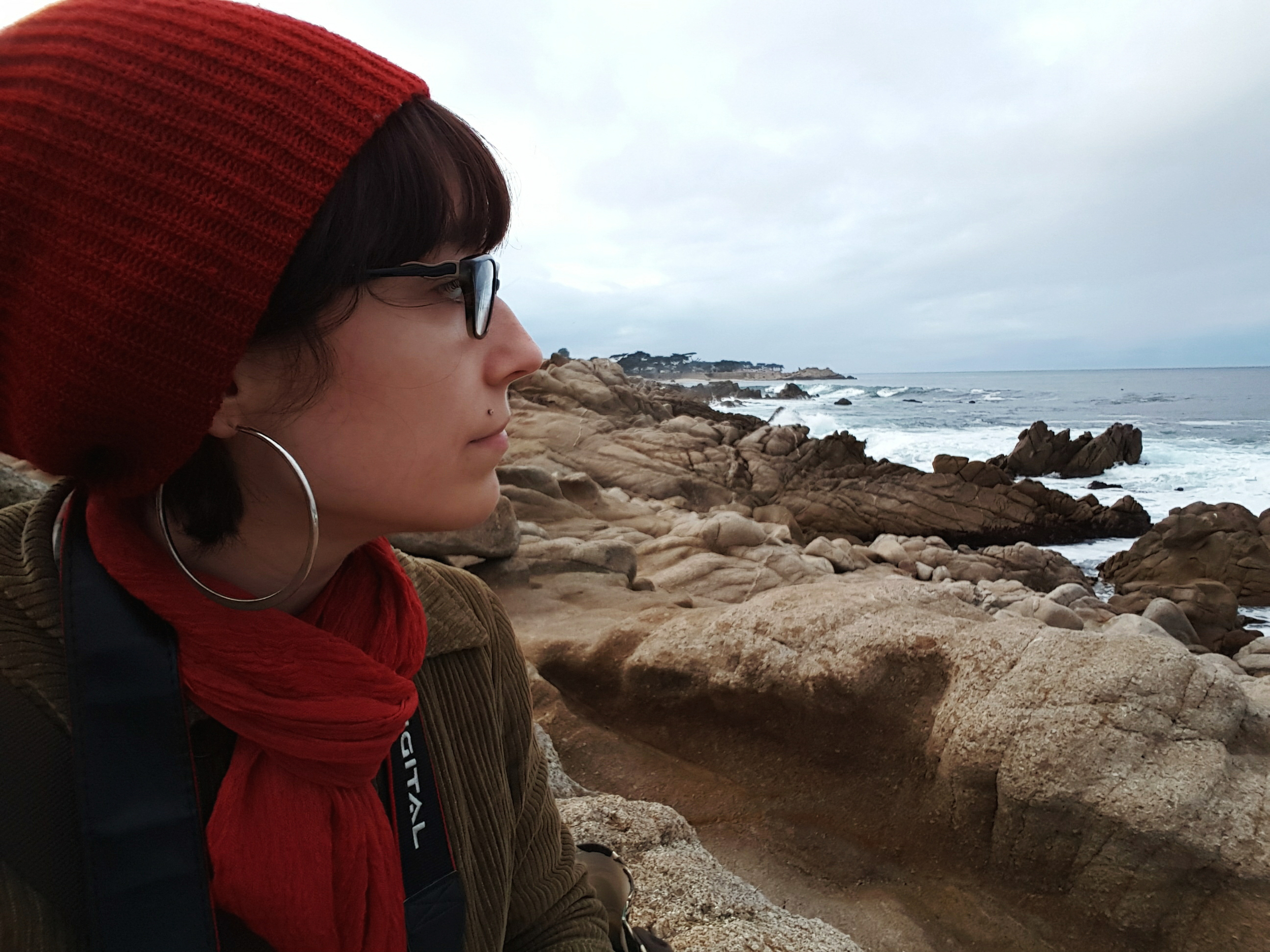 Listening to the crashing waves of the Pacific Ocean on the shore in Pacific Grove, CA