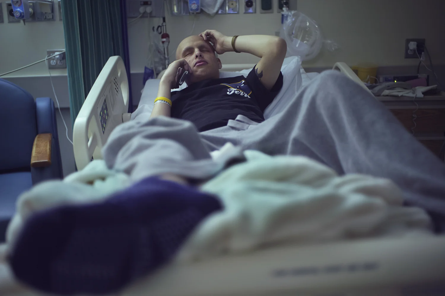  Mitch on the phone with his mother during one of his week long stays at the hospital, where he undergoes daily radiation treatment.&nbsp;  Mitch, diagnosed at age&nbsp;20, &nbsp;was required to undergo approximately 19 alternating weeks of radiation