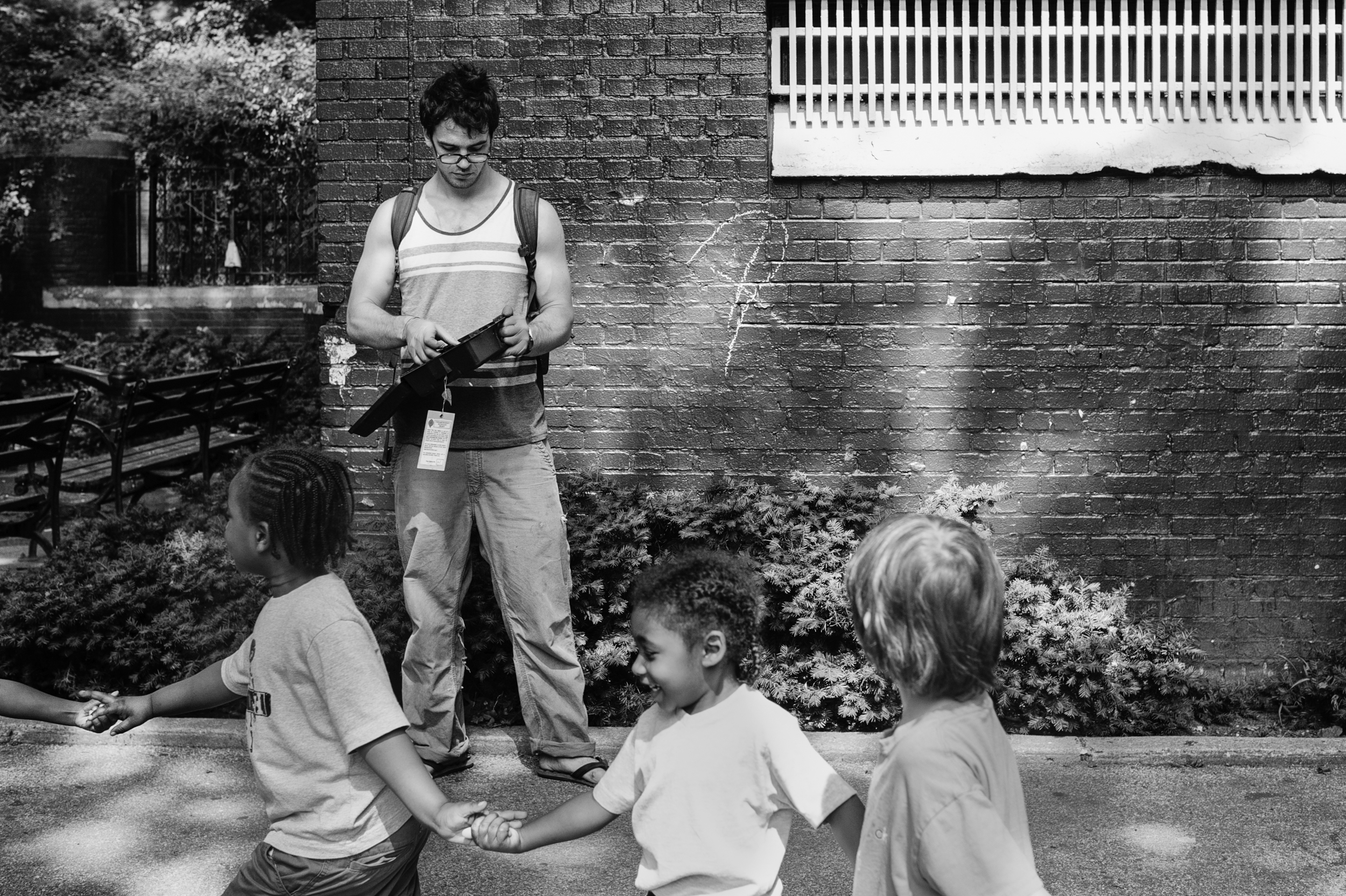      Otis Wood checks a trap on Bradhurst Ave at the 149th st playground in Jackie Robinson Park. &nbsp;Two teams of two Fordham University students began setting non-poisonous rat traps at the beginning of the summer. &nbsp; Playgrounds are generall