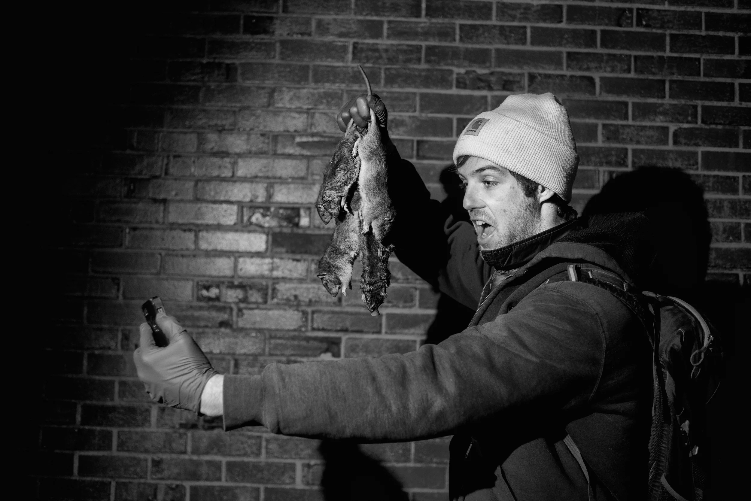  Matt holds up the night's successes for a selfie. &nbsp;A group of men and women train their dogs to help rid of the city's immense rat population, often catching up to 20 rats in a single night, among a group of approximately 10 dog owners. &nbsp;E