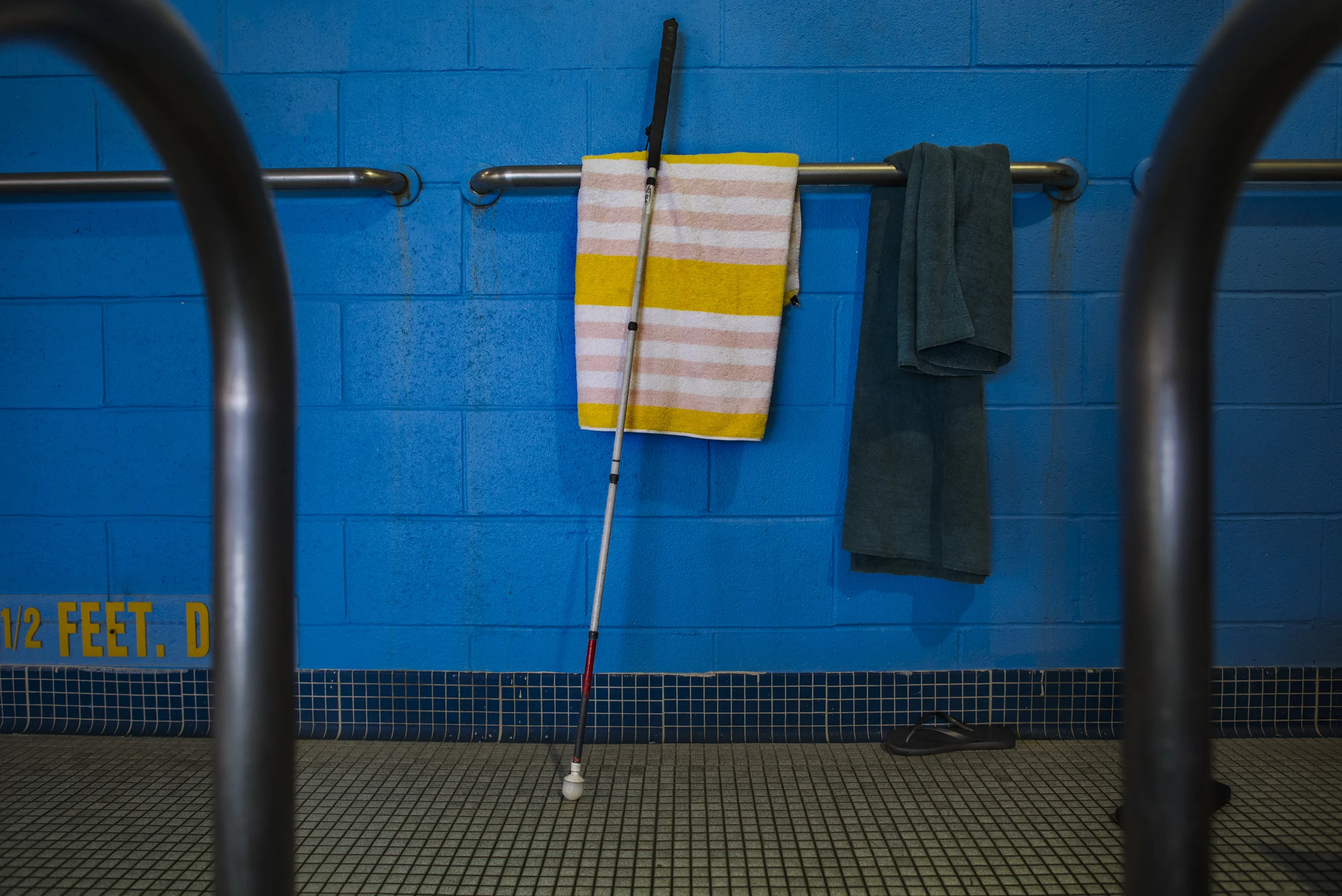  Devin’s folding walking cane sits along the wall at the YMCA pool.  Devin and the members of his dojo participate in water aerobics regularly. 