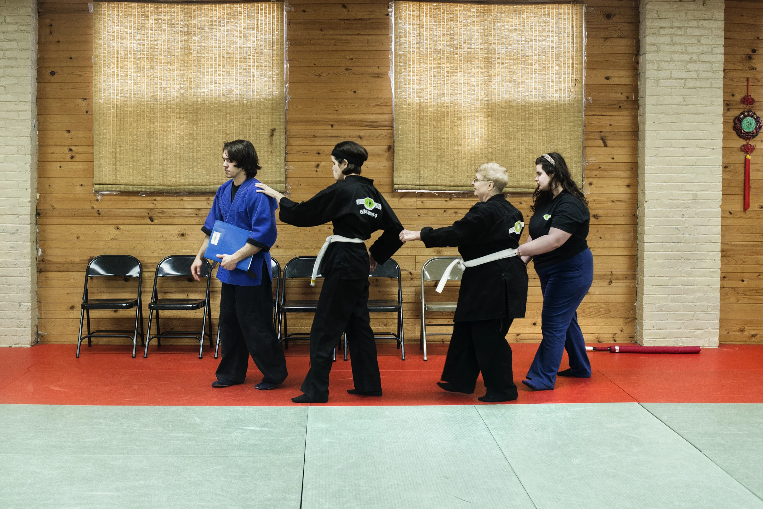  Members of the dojo use each other to guide themselves around the mat 