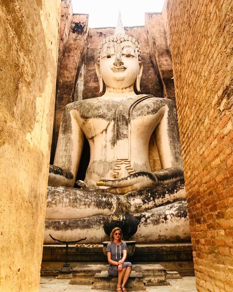 Exploring the country's Buddhist traditions at Wat Si Chum in Sukhothai, Thailand