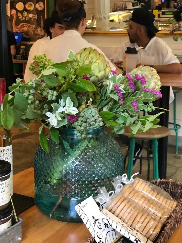 recycled glass jar filled with seasonal flowers and foliage.jpg