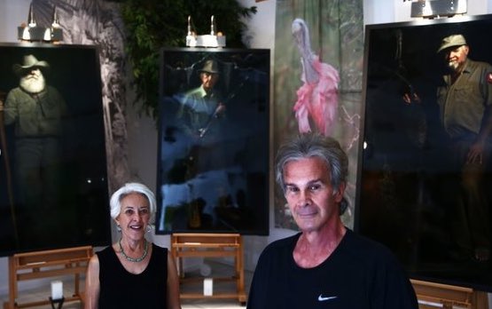 Connie Bransilver and Nicholas Petrucci with Guardians of the Everglades portraits and silk banners.