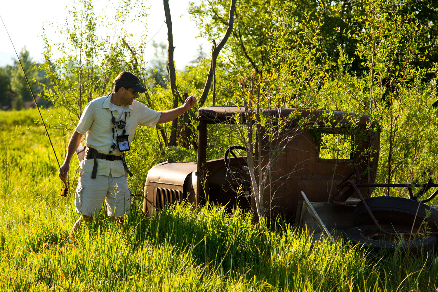  Lifestyle: Peter Sheetz exploring an old rusty truck while fly fishing, Carbondale, Colorado 