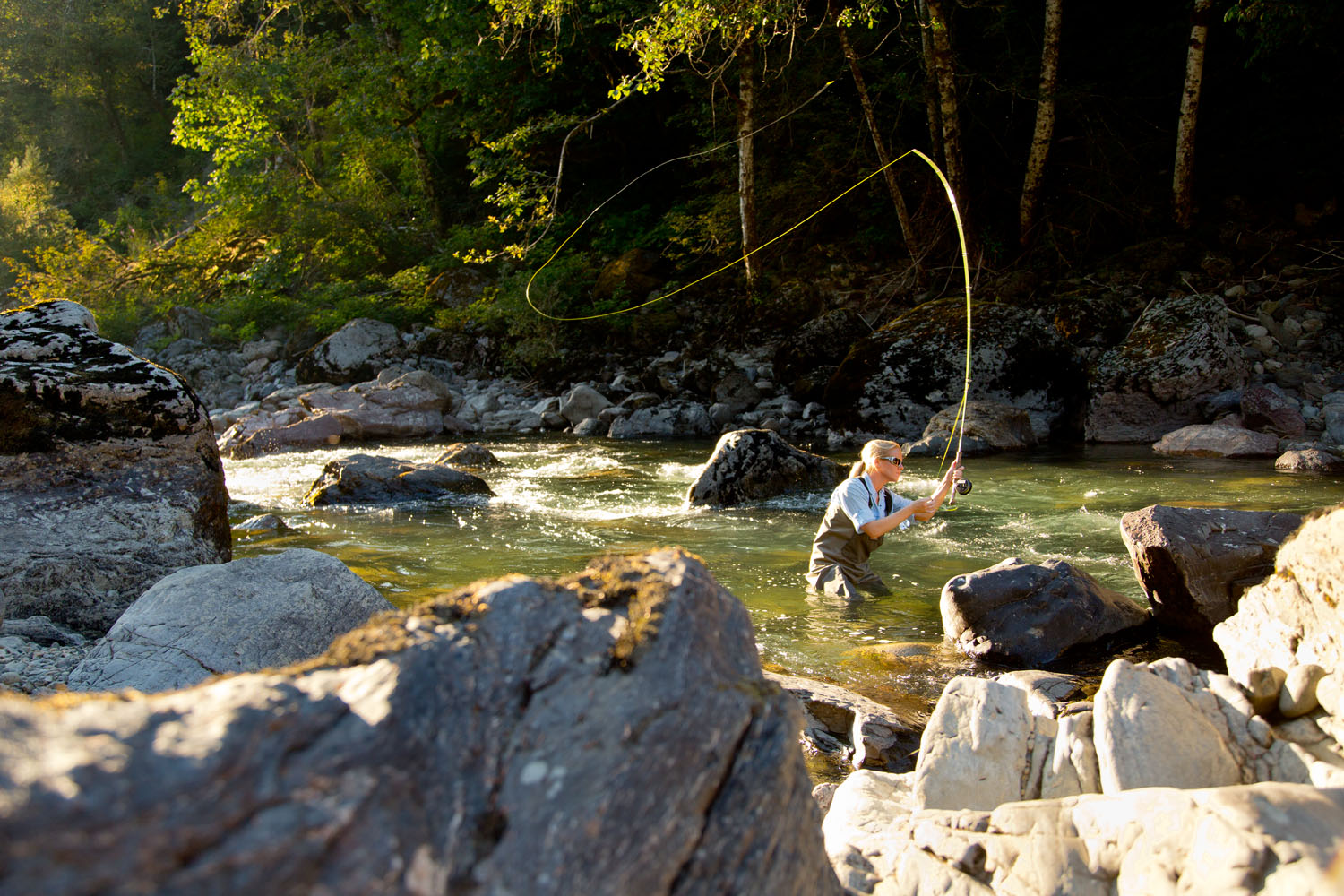  Lifestyle: Kathleen Hasenoerhl fly fishing on the South Fork of the Stillaguamish River in late summer, Central Cascades 