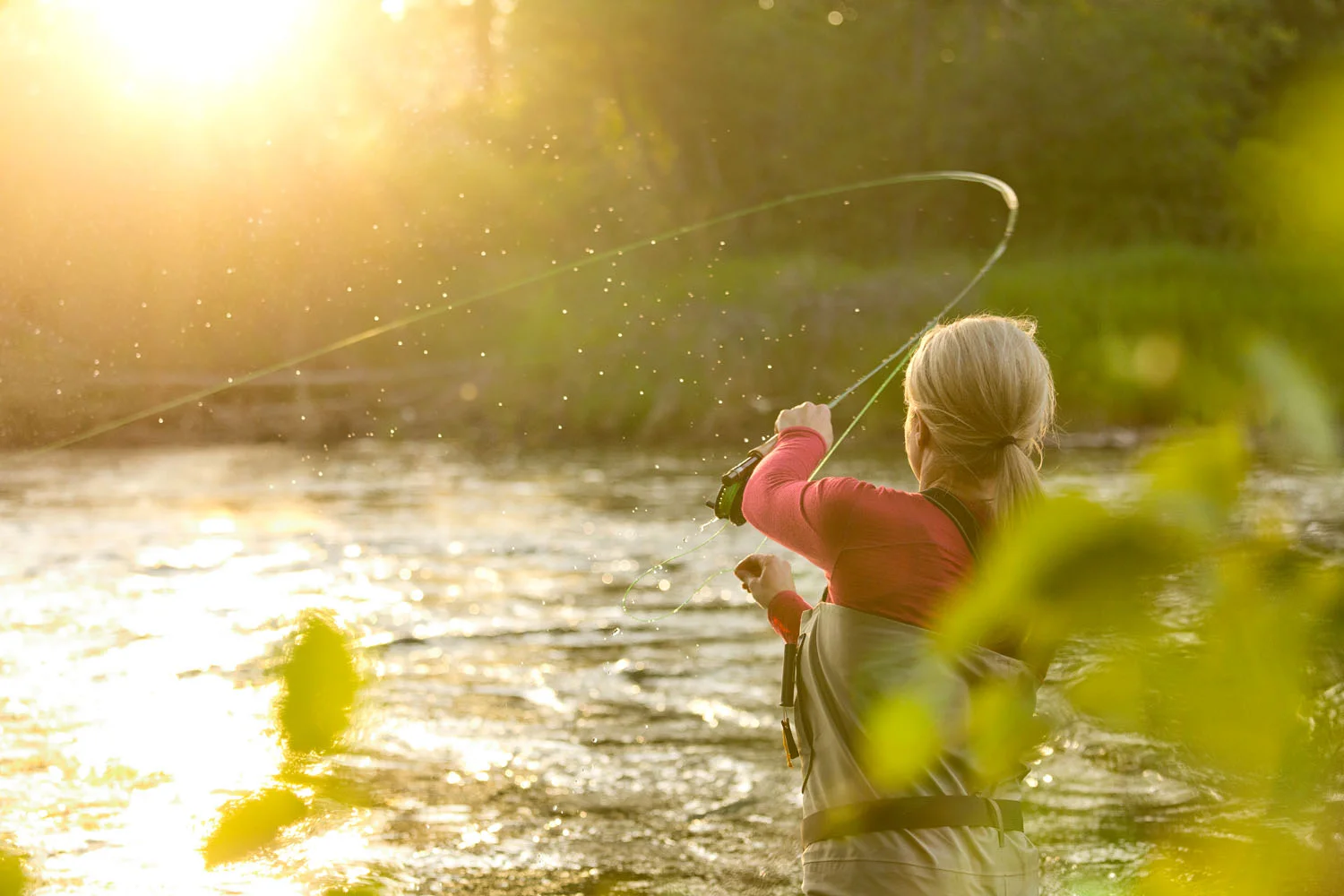 Lifestyle: Kathleen Hasenoehrl fly fishing on the Yakima River at sunset, Central Cascades, Washington