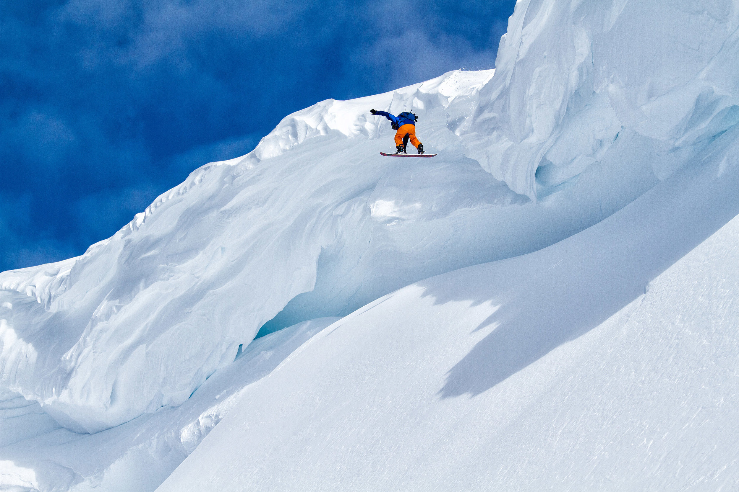  Adventure: Shawn Freyer drops off a huge cornice while snowboarding in the Mt. Baker backcountry, Mt. Baker Wilderness 