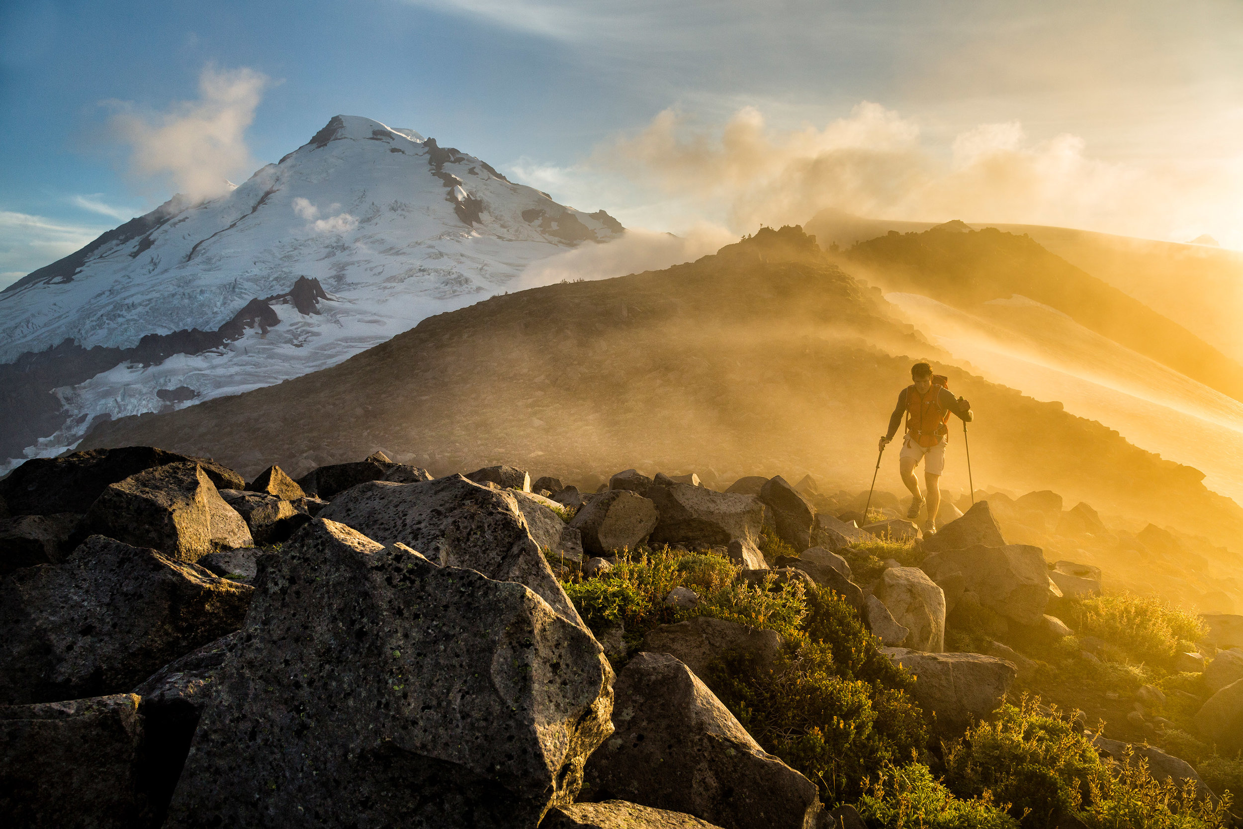  Adventure: Michael Hildebrand hiking through fog at sunset below Mt. Baker, Mt. Baker Wilderness, Washington 