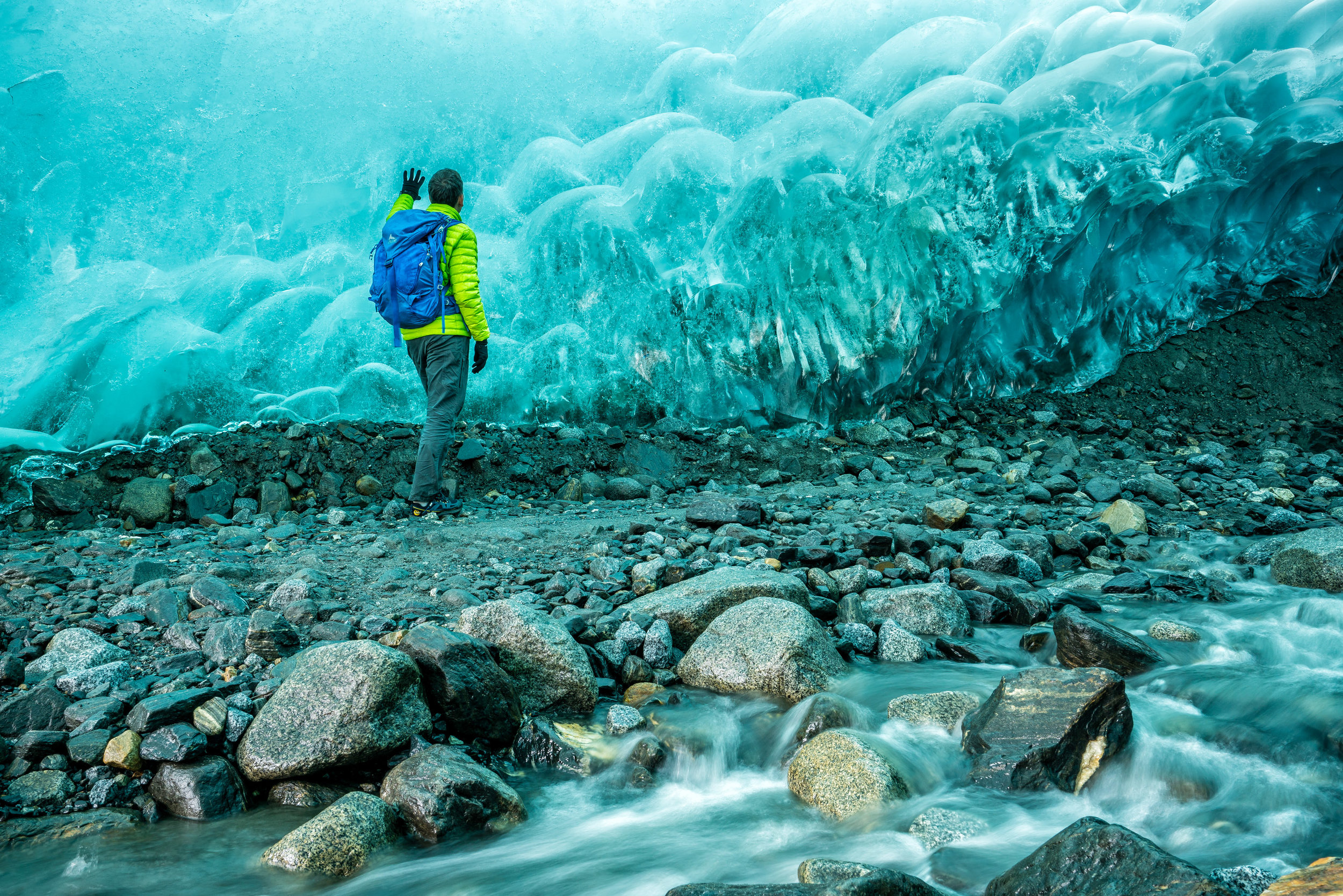  Adventure: A man explores an ice cave beneath the Mendenhall Glacier, Juneau Icefield, Alaska 