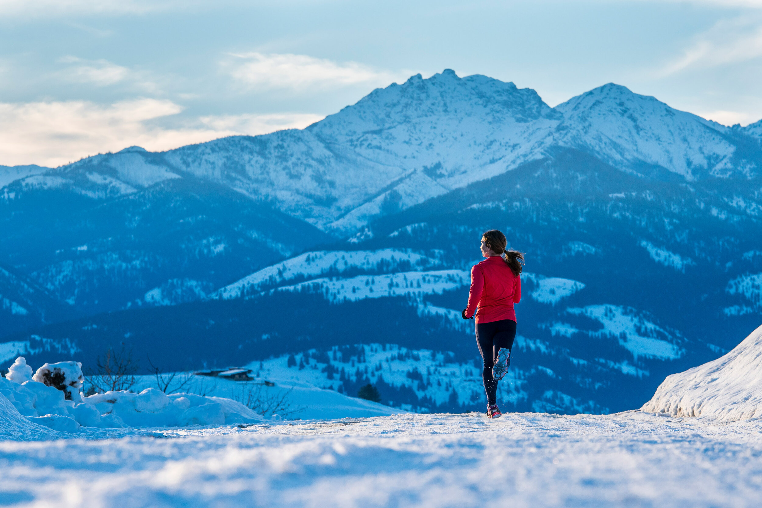  Adventure: Brianna Graves running through the snow on a sunny winter day in the Methow Valley, Washington 