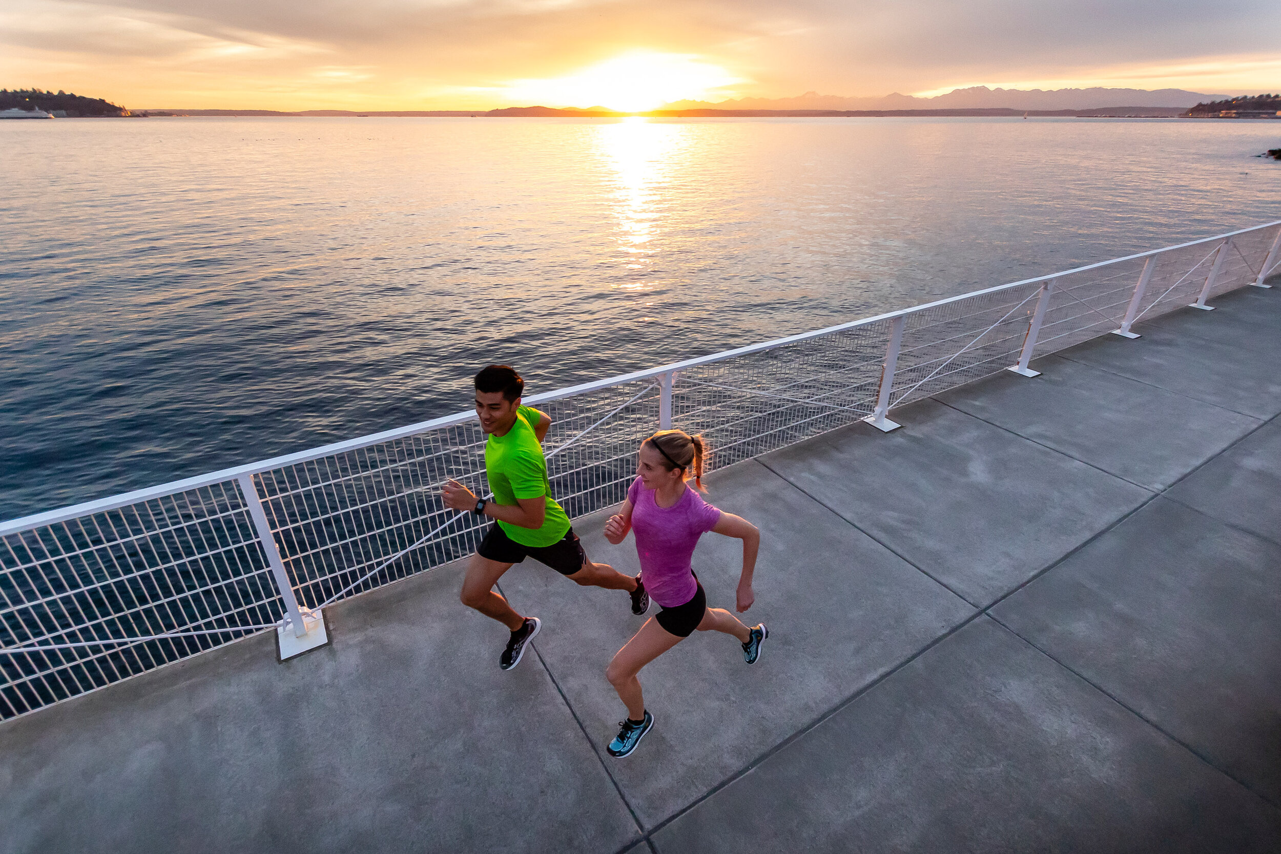  Lifestyle: Andrew Ignacio and Bronwyn Crossman running along the Seattle waterfront at sunset, Olympic Sculpture Park 