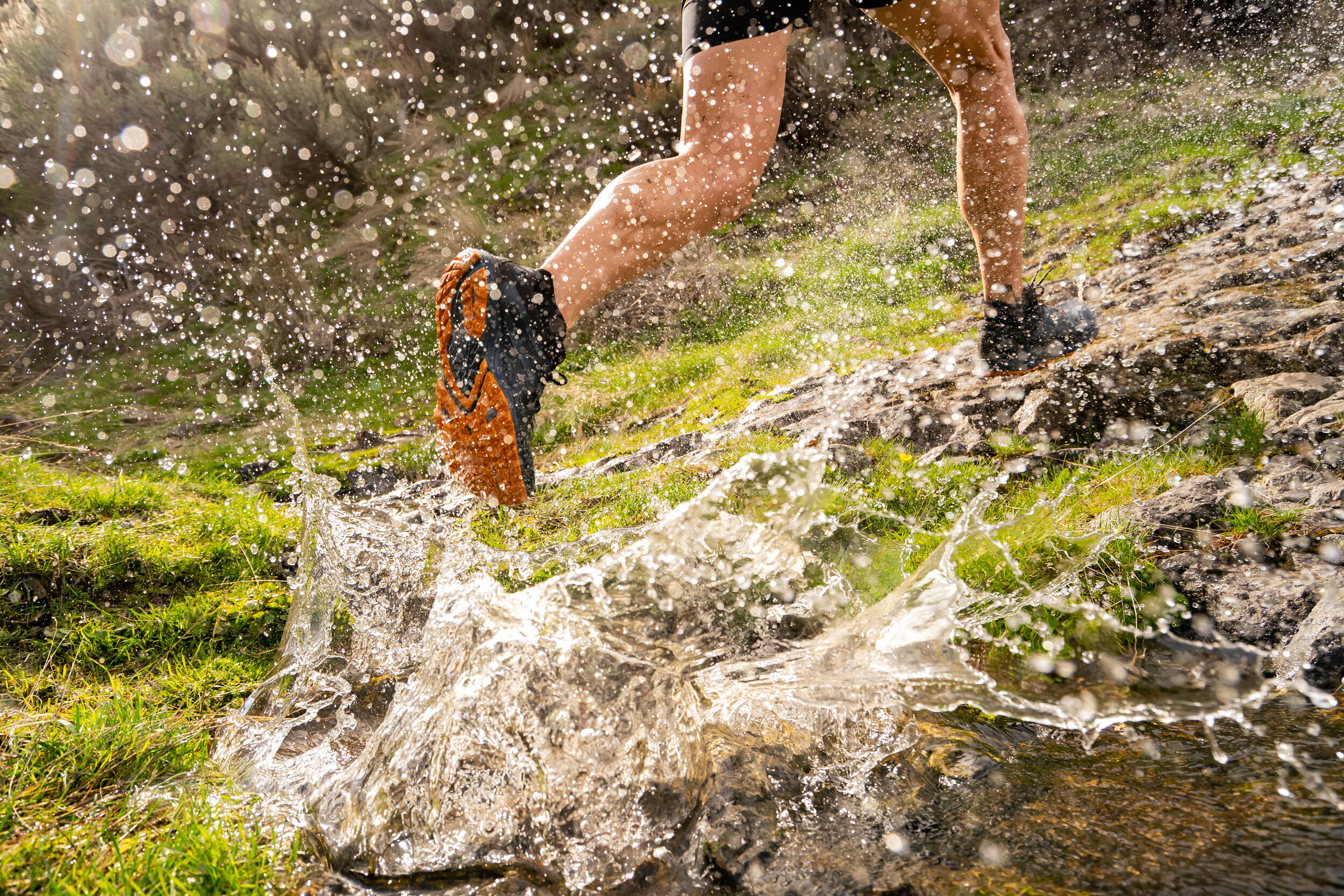  Adventure: Andrew O'Connor spashes through a creek while trail running near a waterfall in Yakima Canyon, Washington 