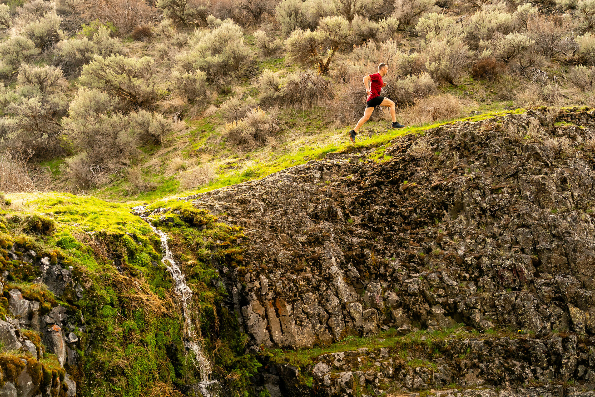  Adventure: Andrew O'Connor trail running near a waterfall in Yakima Canyon, Washington 