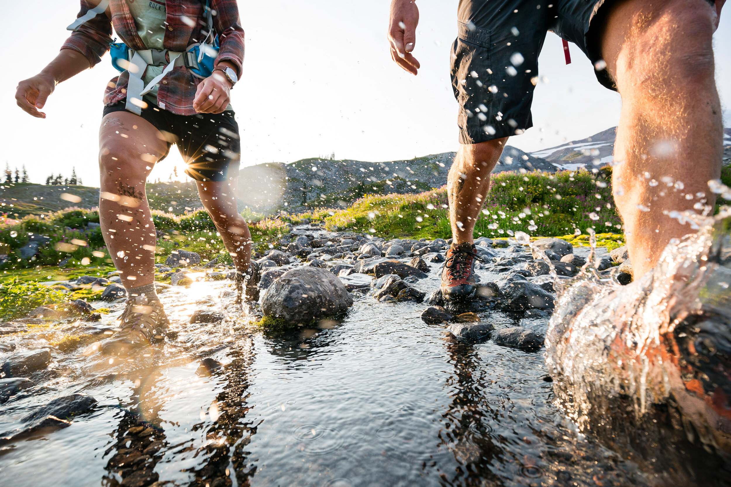  Adventure: Holly Johnson and Michael Hildebrand crossing a creek while hiking in Mt. Rainier National Park 