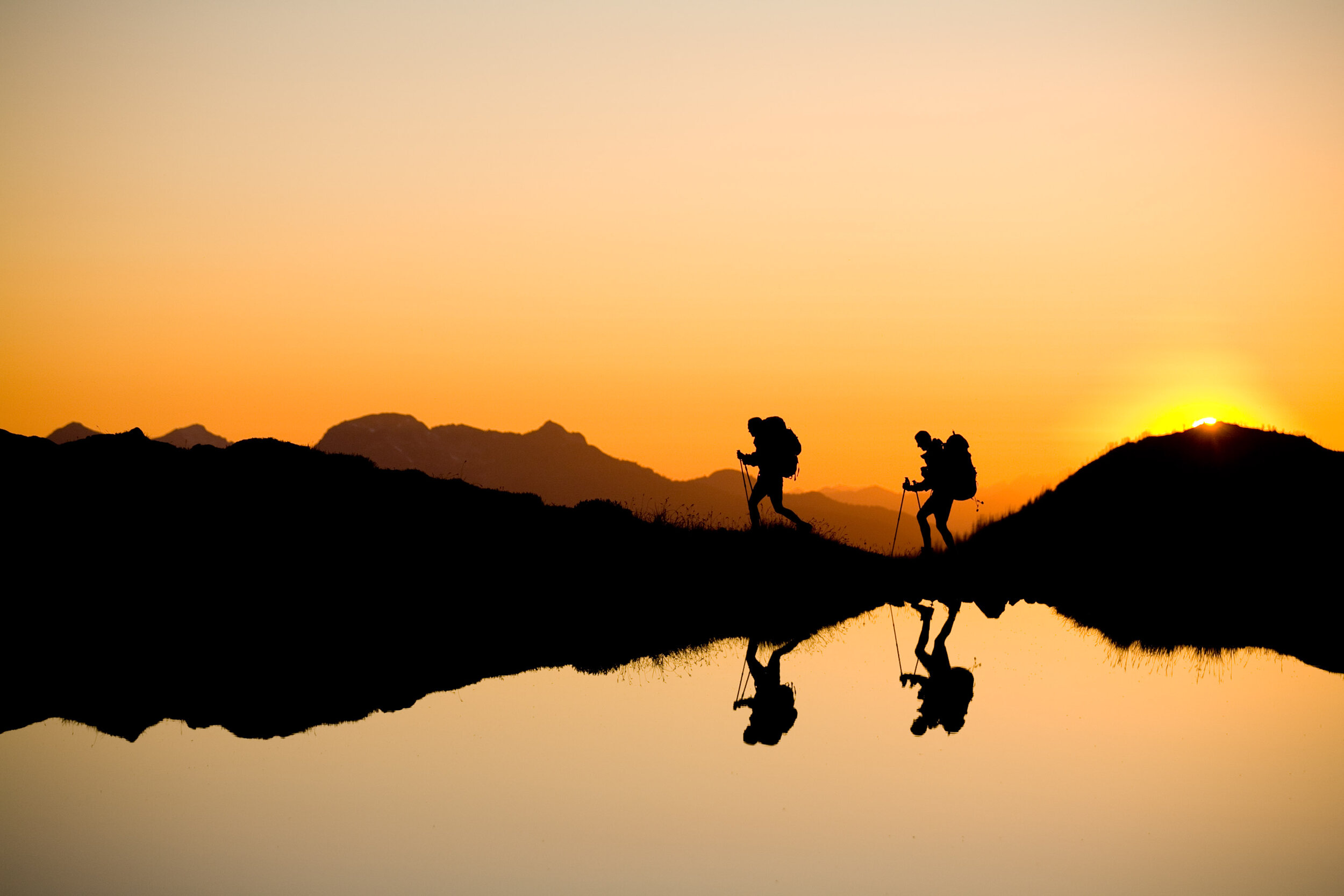  Adventure: Sandy Weil and Karen Schooley hiking near Kool-Aid Lake at sunset, North Cascades 