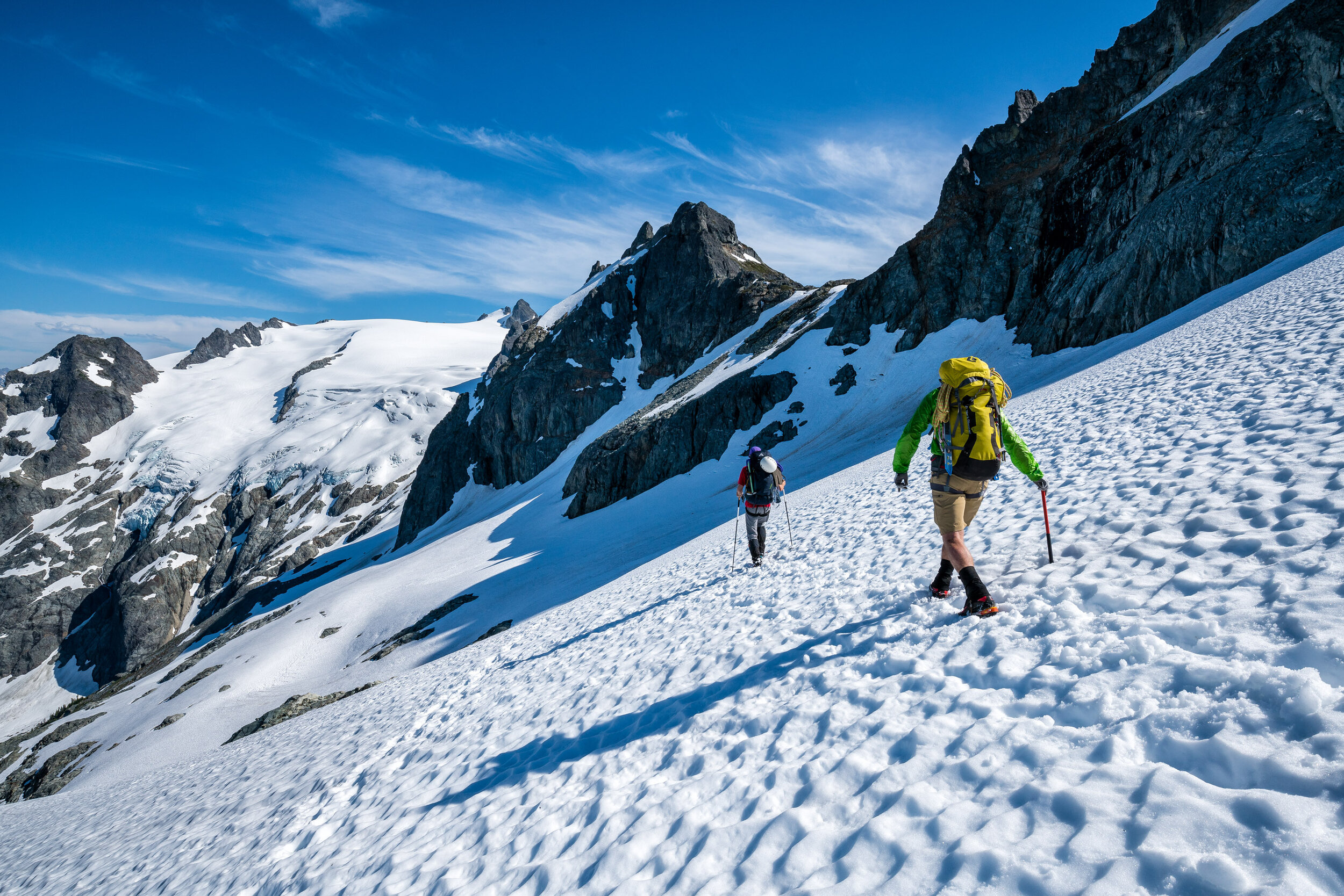  Adventure: A group of climbers traversing a snowy slope on the Ptarmigan Traverse, North Cascades, Washington 