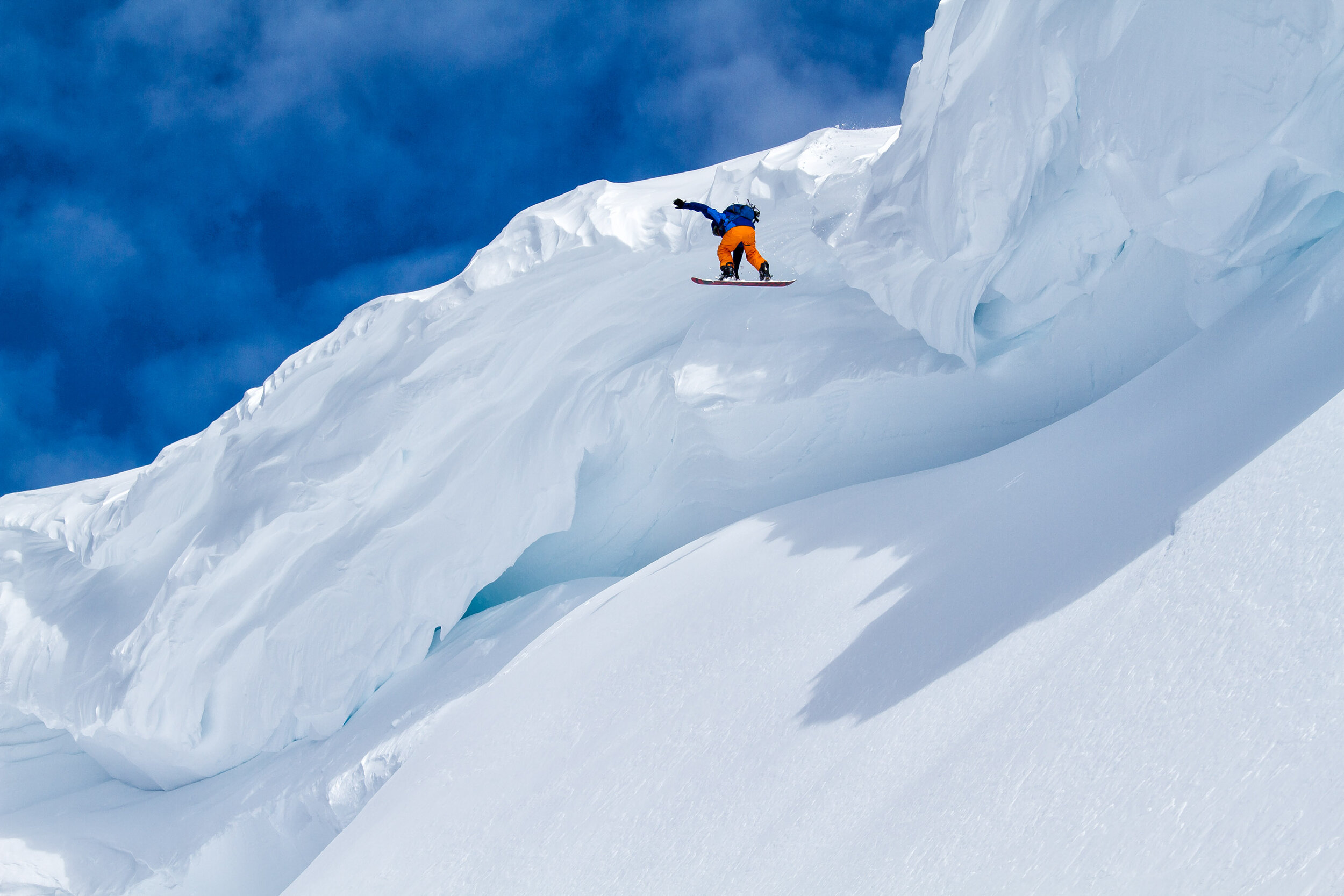  Adventure: Shawn Freyer drops off a huge cornice while snowboarding in the Mt. Baker backcountry, Mt. Baker Wilderness 