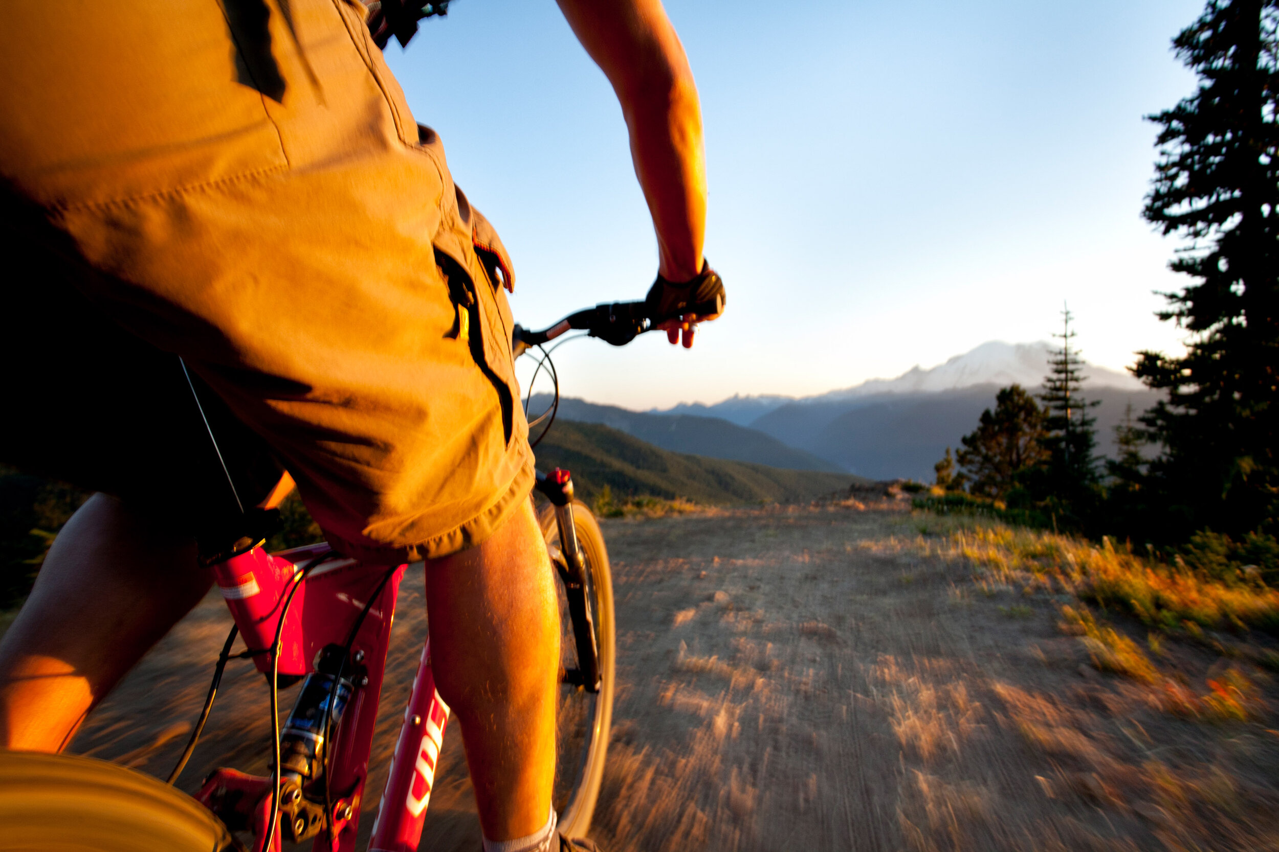 Adventure: Bryan Terrell mountain biking at sunset on Noble Knob in view of Mt. Rainier 