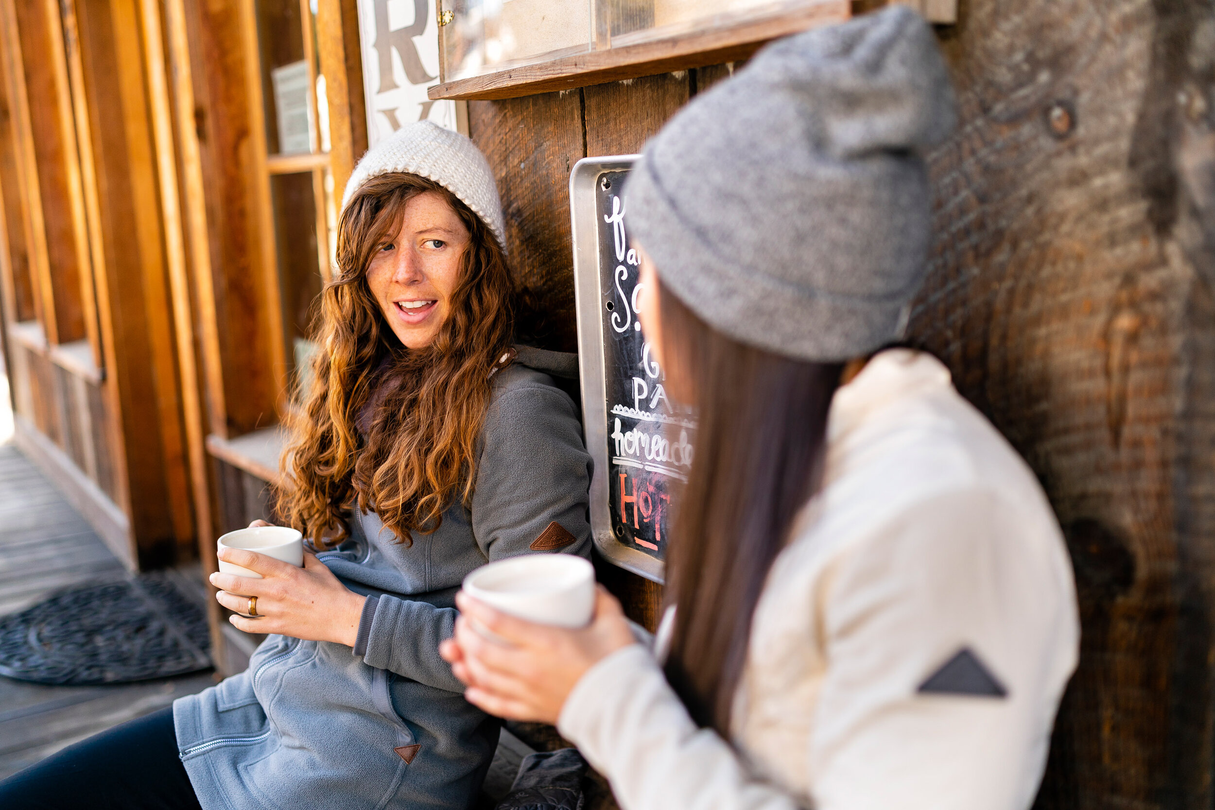  Lifestyle: Keri Moore and Rella Billie drink coffee outside the Rocking Horse Bakery in winter in Winthrop, Methow Valley, Washington 