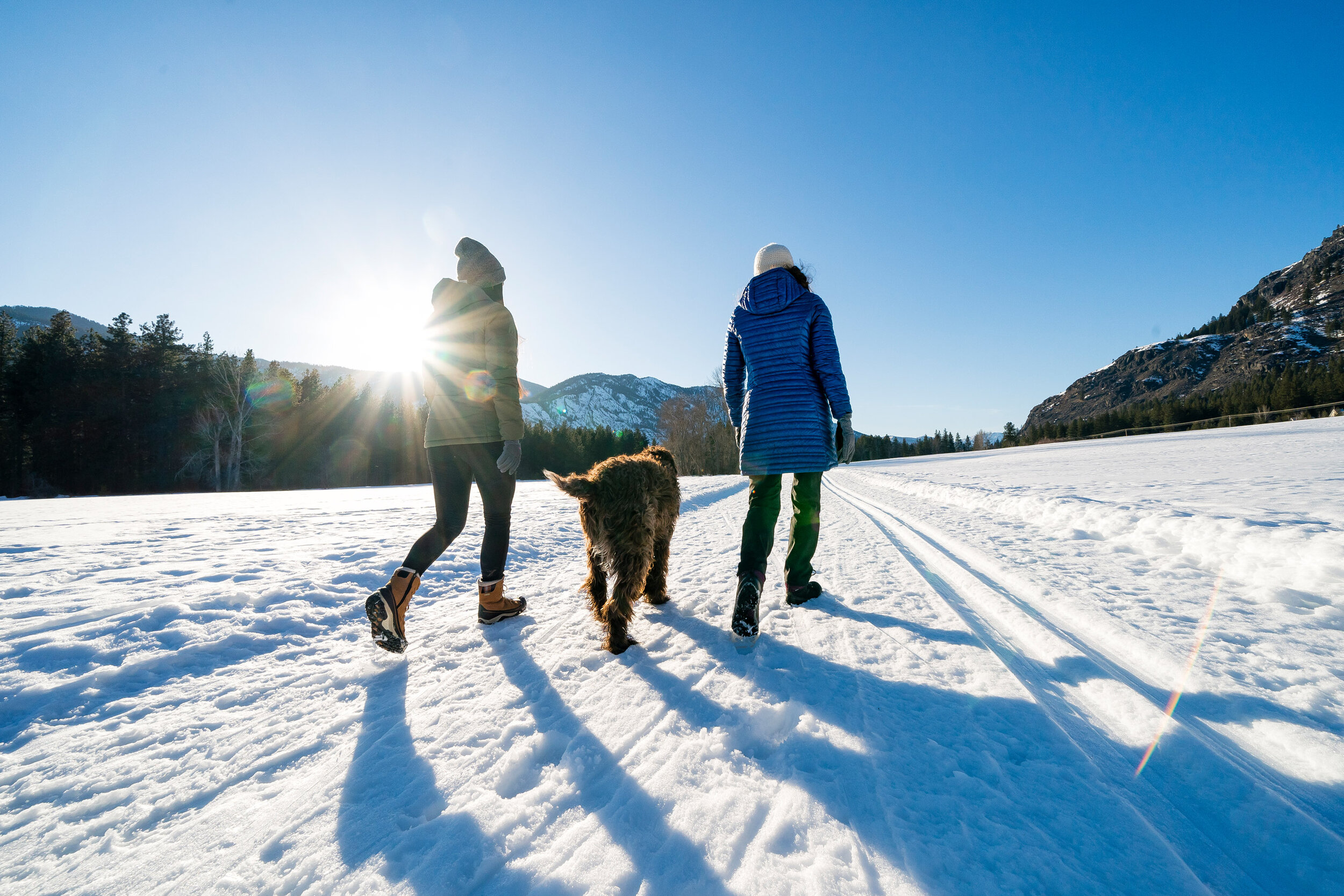  Lifestyle: Keri Moore and Rella Bille walking a dog in the Methow Valley in winter 